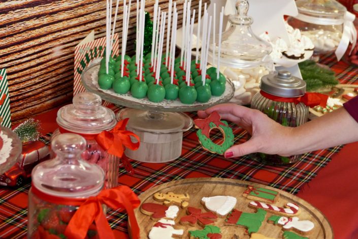 Goûter de Noël par Studio Candy chez Estée Lauder - Candy Bar / Bar à bonbons et pâtisseries - sablés décorés de Noël sucre d'orge, luge, bonnet de père noel, bonhomme de pain d'épice, ours polaire. Cake pops au chocolat, cupcakes, sapins meringue décorés. Décoration rouge vintage et tartan écossais avec sapin, patin à glace, petit train, pommes de pin