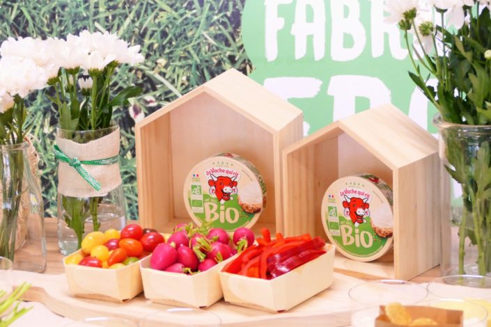 scénographie nature pour le lancement de Vache qui rit Bio - fleurs, basilic, bouteilles de lait, bar à pains, crudités, bois