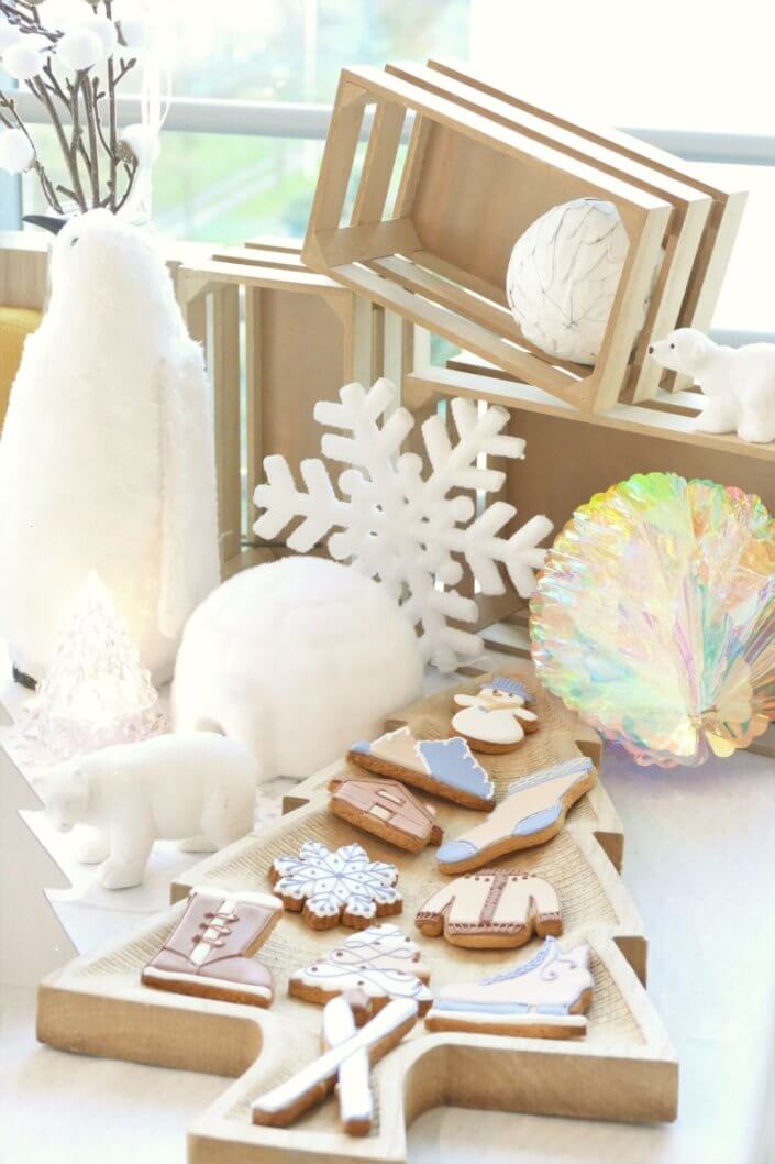 Goûter de Noël Polaire avec une décoration hiver enneigé en blanc : sapins pailletés, ours, pingouin, igloo. Fontaines à boissons, sapins meringue, financiers, sablés décorés de Noël