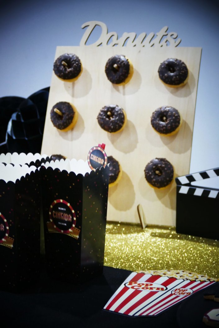 Goûter thème cinéma pour le film Hors Normes avec sablés décorés pot de pop corn, ticket de cinéma, caméra, clap, étoile dorée, bobine, candy bar et décoration sur mesure