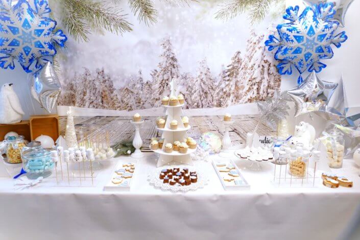 Goûter de Noël Polaire avec mini cupcakes, cakepops, brochettes de chamallows, candybar, boissons, décoration hiver polaire en blanc, argent et bleu glacier