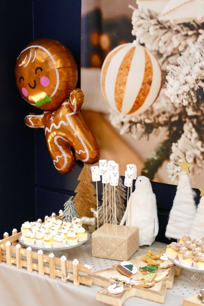 Noel nature par studio candy avec une décoration en beige et doré, des cakepops au chocolat, des mini cupcakes, des sablés décorés de Noël, un candy bar de chocolats et des ballons mignons pour les enfants