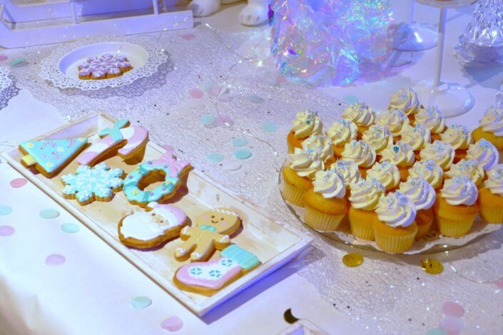 winter wonderland au gouter réalisé chez unibail par studio candy avec des sapins meringue, des cupcakes, des cakepops des sablés décorés de Noël, un candy bar et une décoration en blanc et pastels