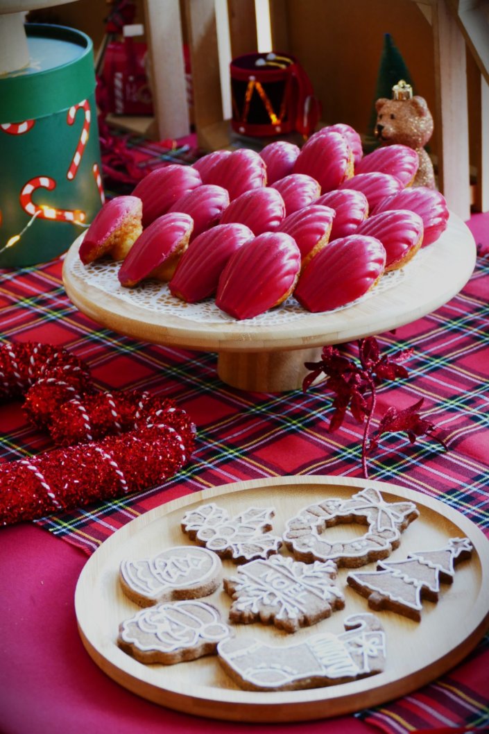 Arbre de Noël chez Inicéa par Studio Candy avec un grand goûter de Noël traditionnel, sablés décorés, cakepops rouges, cupcakes, madeleines à coques rouges, et décoration en rouge, tartan écossais et sucres d'orge