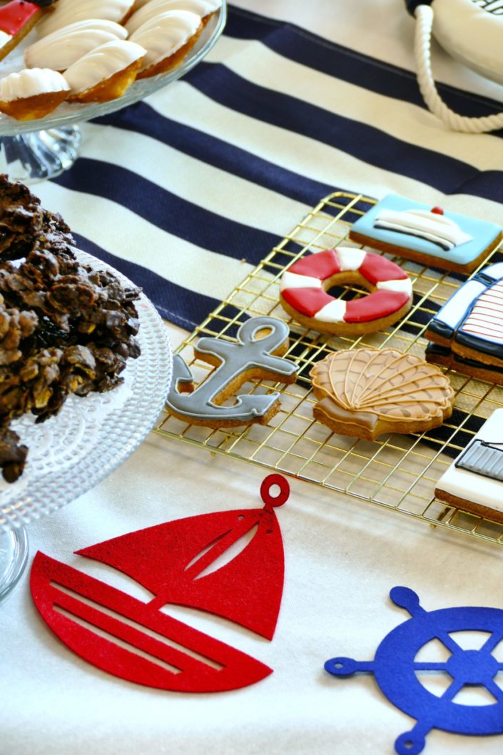 Goûter thème marine pour Axa XL réalisé par studio candy avec une décoration sur mesure, des pâtisseries personnalisées comme des cakepops bleu marine, des sablés ancre, bouée, bateau, coquillage, et une décoration en bleu, blanc et rouge